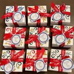 Multiple sets of coasters tied with ribbon on a wooden table