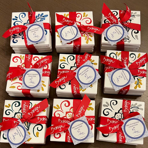 Multiple sets of coasters tied with ribbon on a wooden table