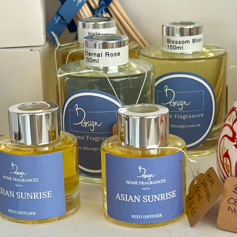 Collection of home fragrance products with '2 Design' branding on a neutral background