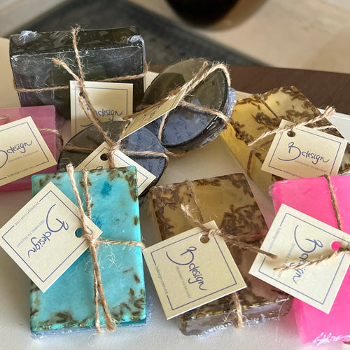 Handmade soap bars with tags on a wooden surface