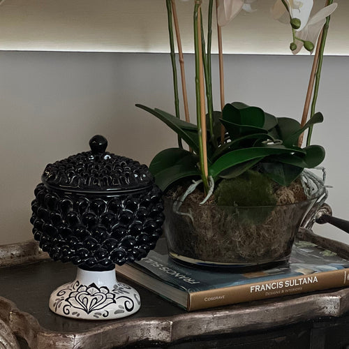 Pine cone with lid used as decor on a trolley in a dining room