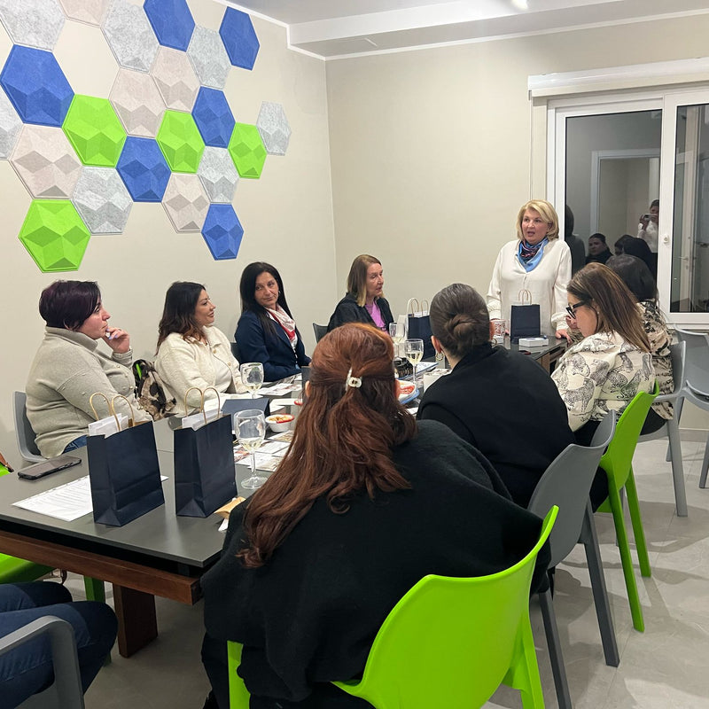 Group of people sitting around a table during a workshop conducted by interior designer Beatrice Migneco